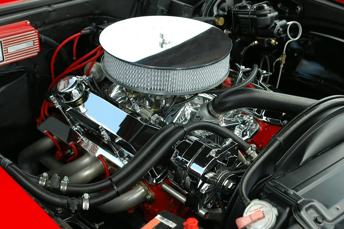 Mechanic inspecting vehicle engine components
