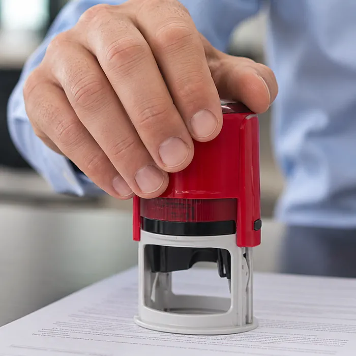 Professional notary stamp resting on signed documents