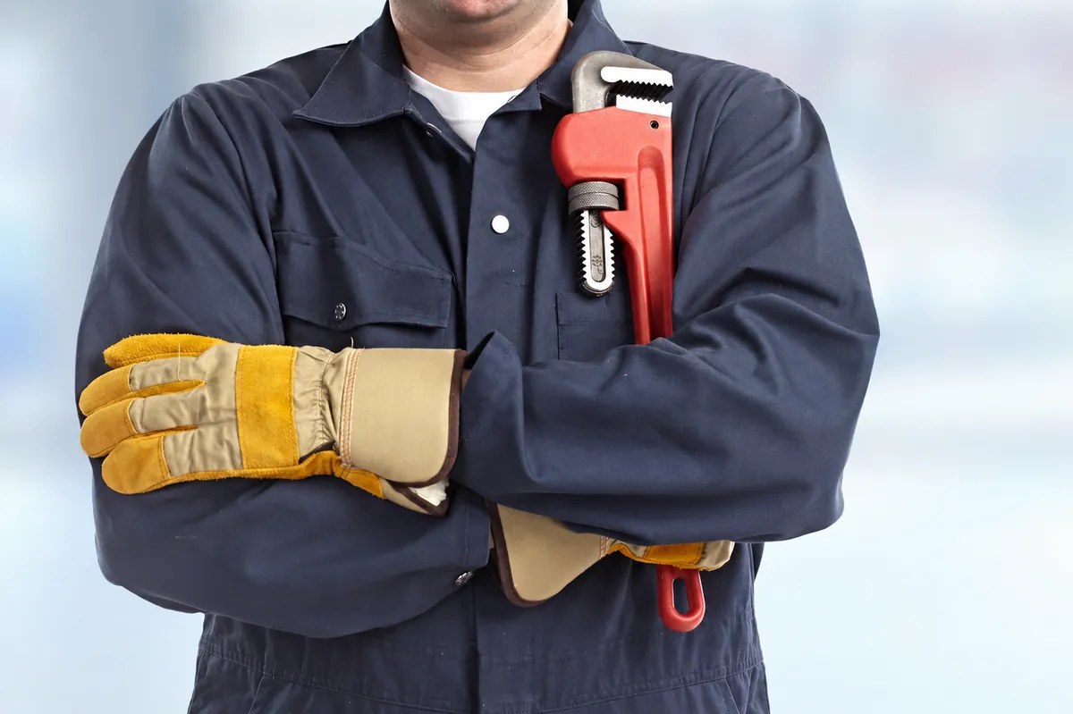 Professional plumber prepared for residential plumbing service