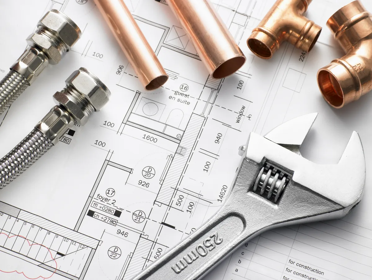 Professional plumbers coordinating residential plumbing service
