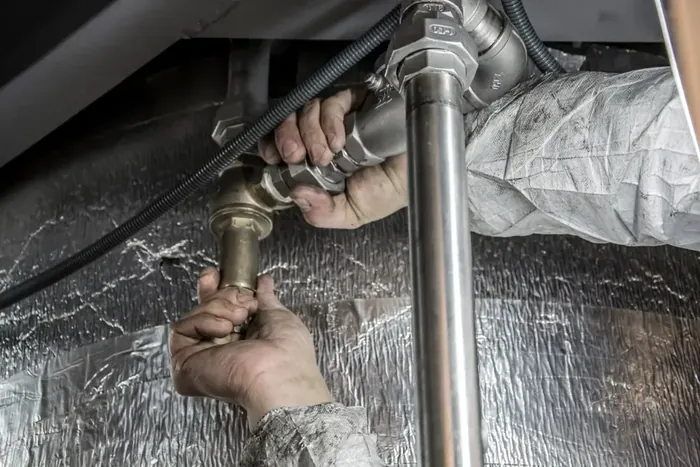Plumber repairing pipe fittings