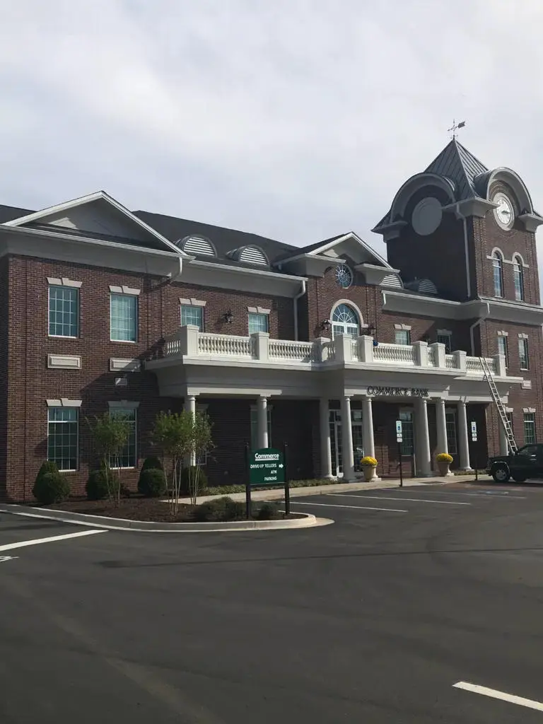 Large brick commercial building with multiple upper-story windows