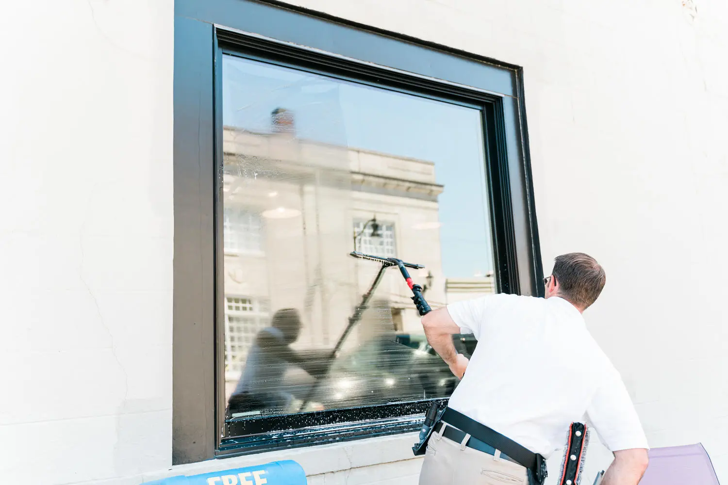 Craig using a professional squeegee on a commercial window