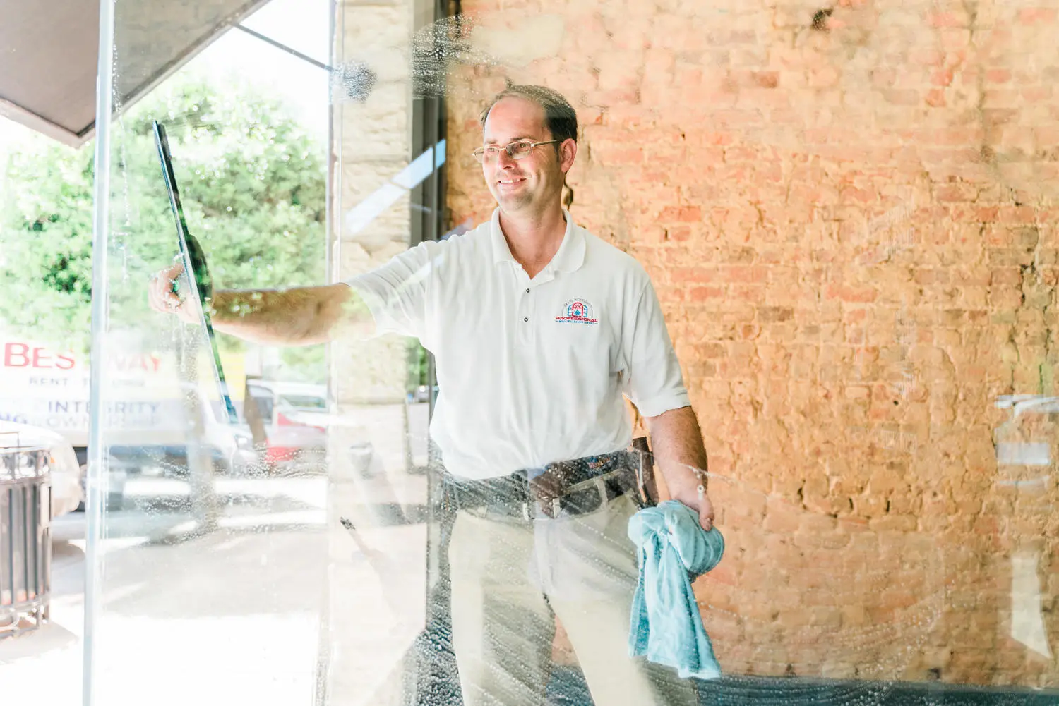 Craig using an extended water-fed pole on an upper-story commercial window