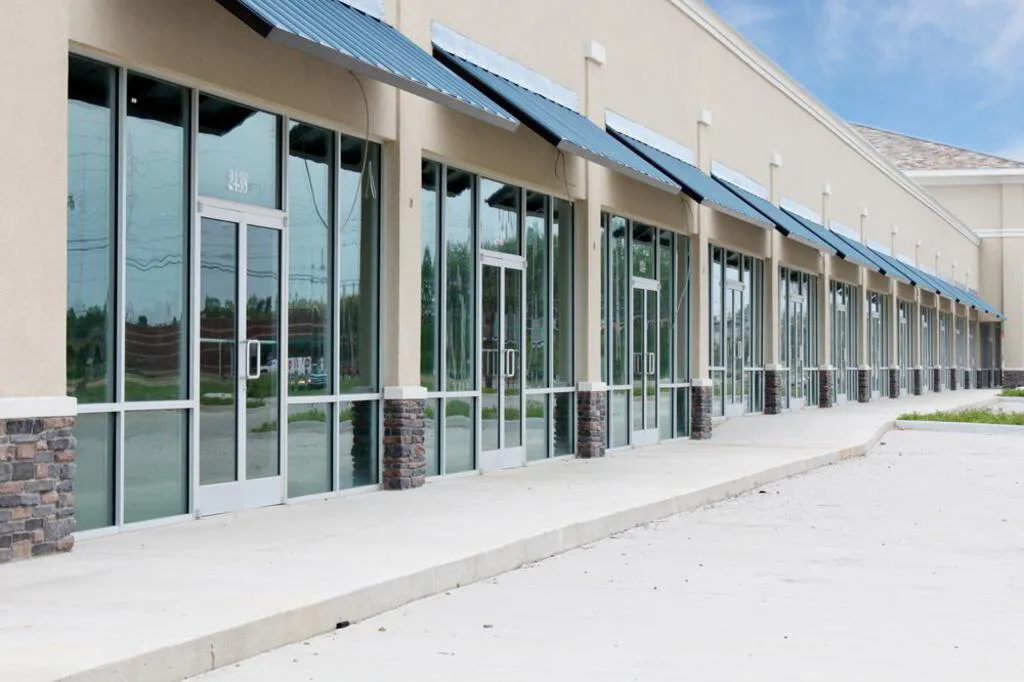Long row of commercial storefront windows at a shopping center