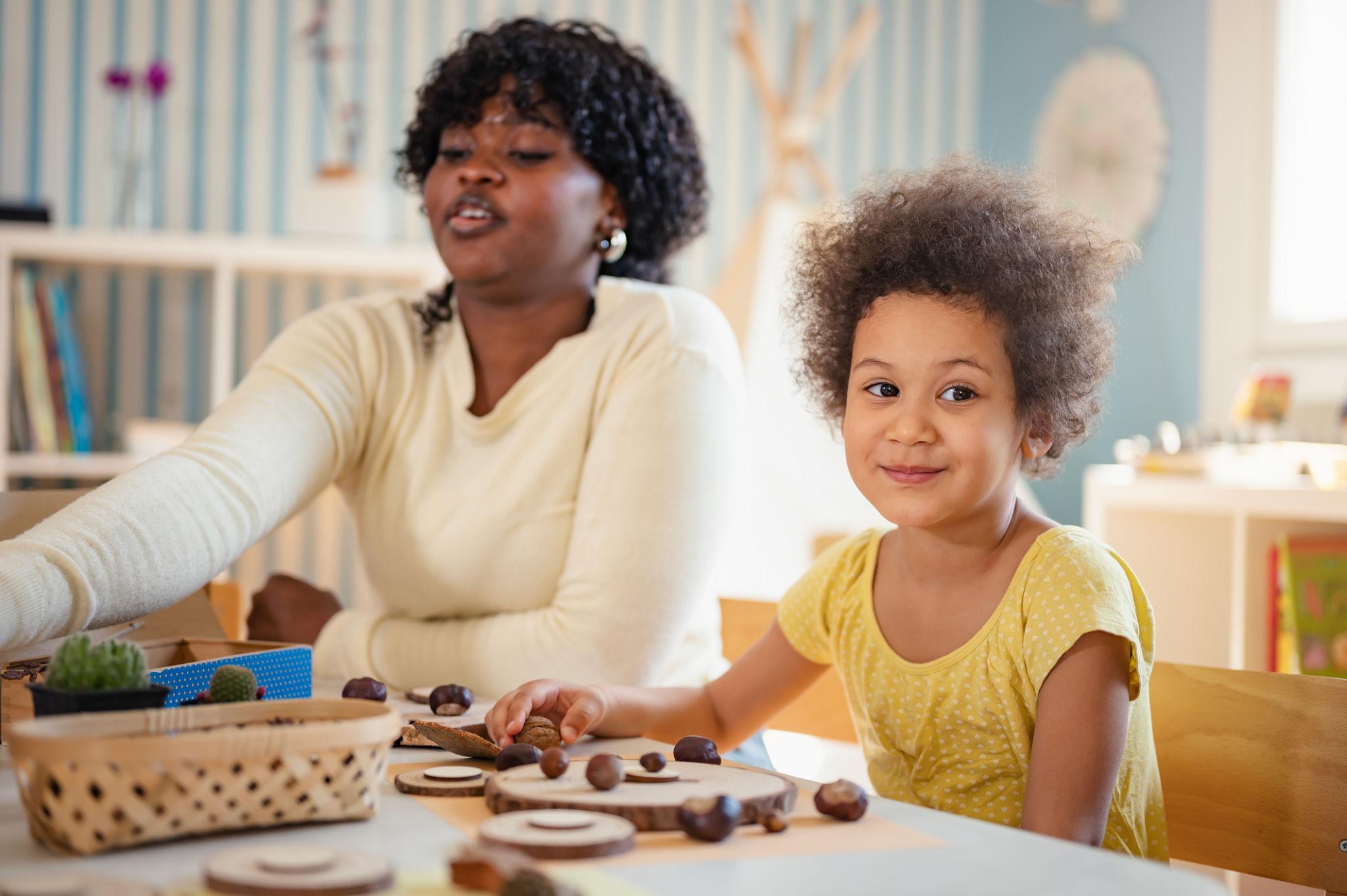 Teacher supporting child in warm pediatric care environment
